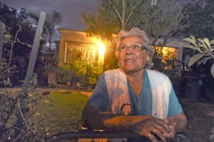 PHOTO BY ROB VARELA, VENTURA COUNTY STAR ROB VARELA/THE STAR Alberta Paramo stands in her front yard across the street from where Alfonso Limon Jr. was shot by police in Oxnard’s La Colonia a year ago.